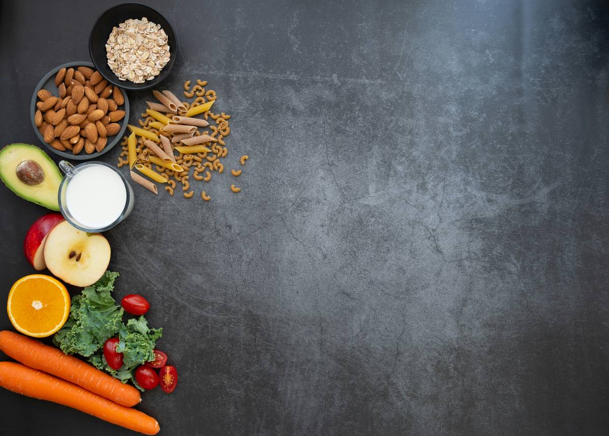 woman following gut health diet book meal plan with fresh vegetables and bone broth